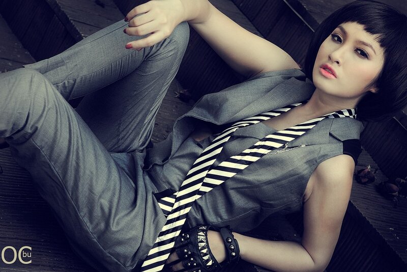 woman in grey suit with tie