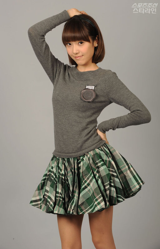 woman in grey sweater and plaid skirt