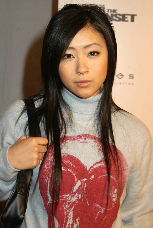 woman in grey sweater with red graphic
