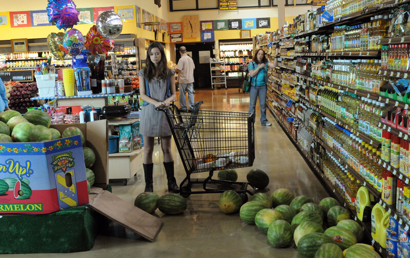 Woman in grocery store aisle