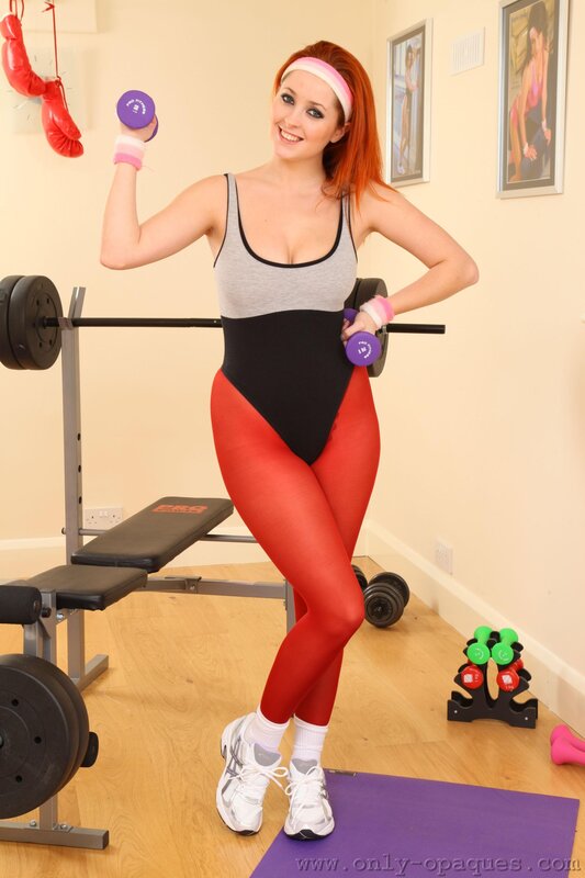 Woman in gym with dumbbells