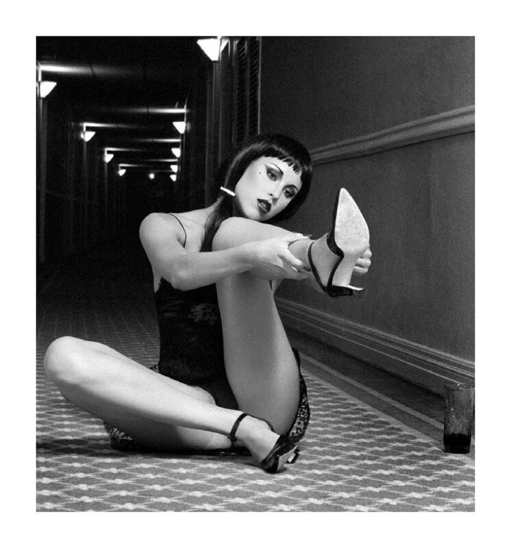 woman in hallway adjusting shoe