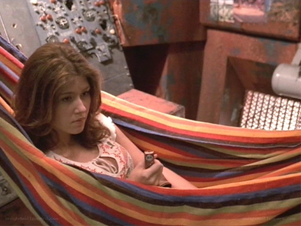 woman in hammock holding object