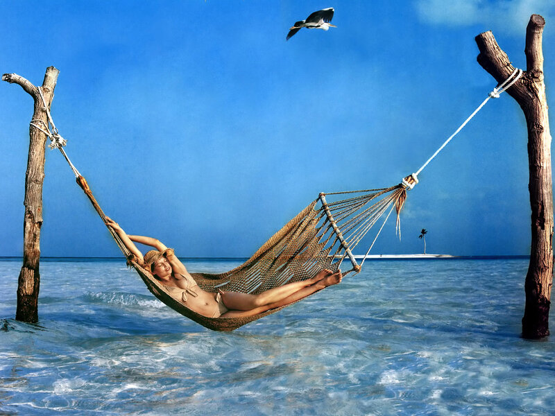 Woman in hammock on beach