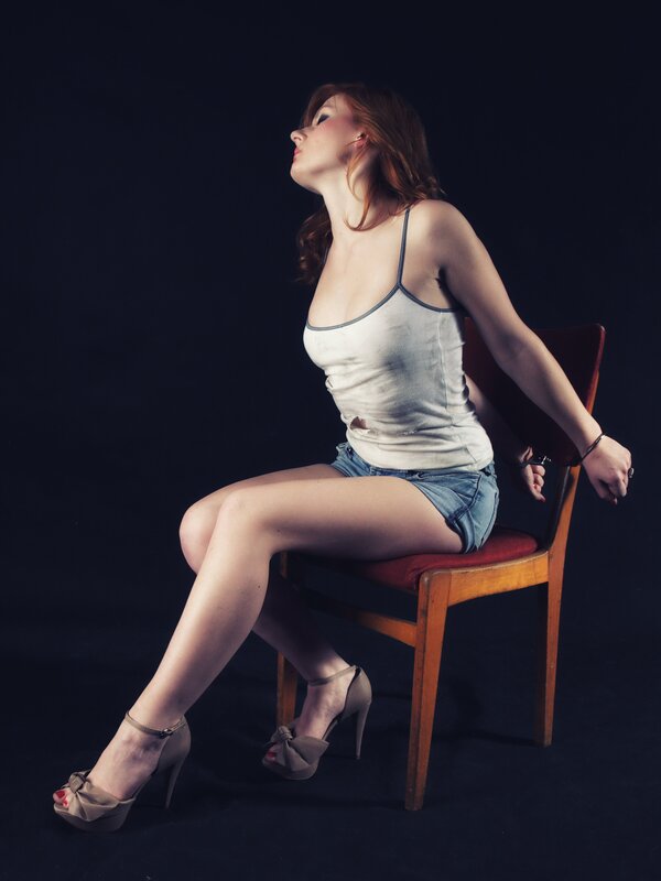 woman in handcuffs on chair