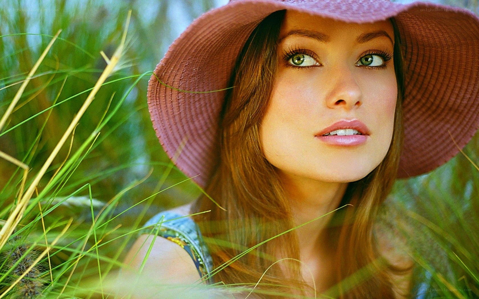 woman in hat among grass