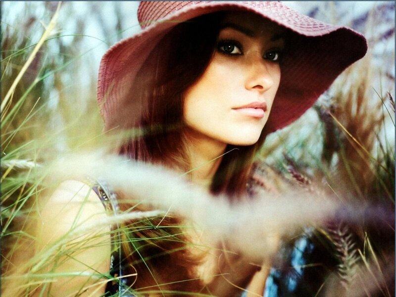 woman in hat among tall grass
