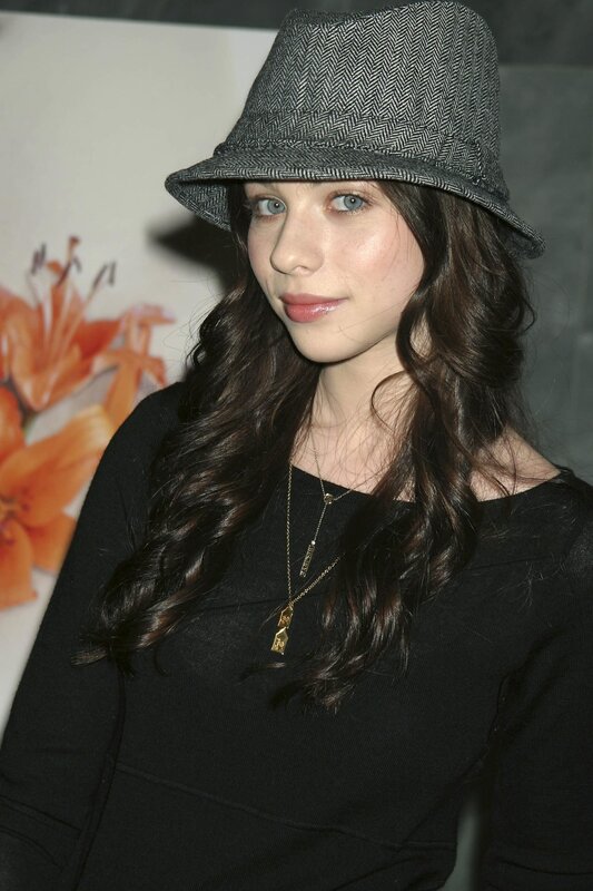 woman in hat and black top
