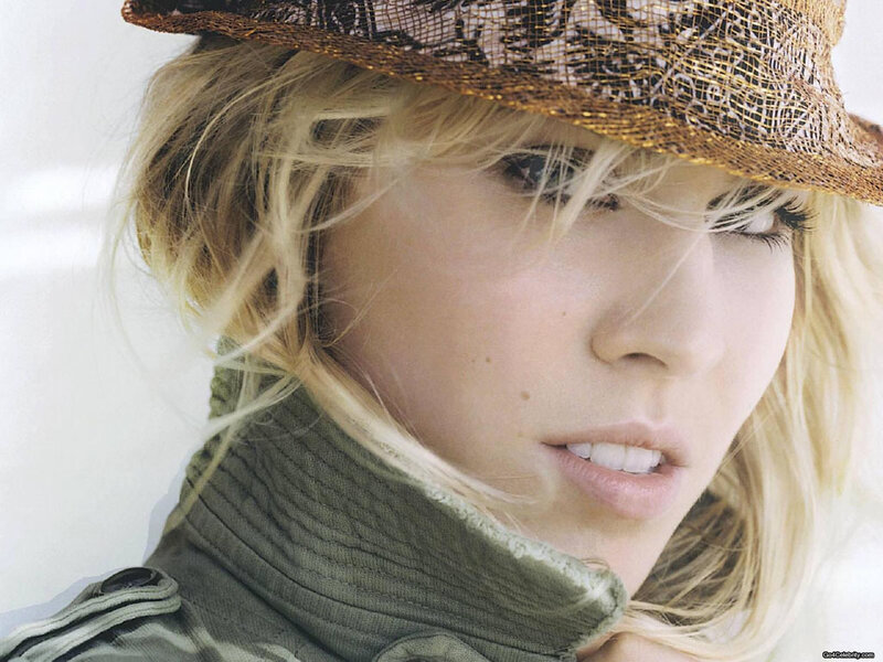 woman in hat and green jacket