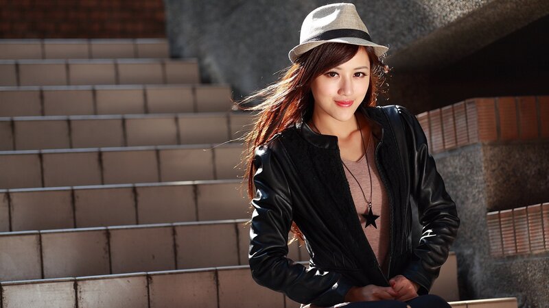 woman in hat and leather jacket