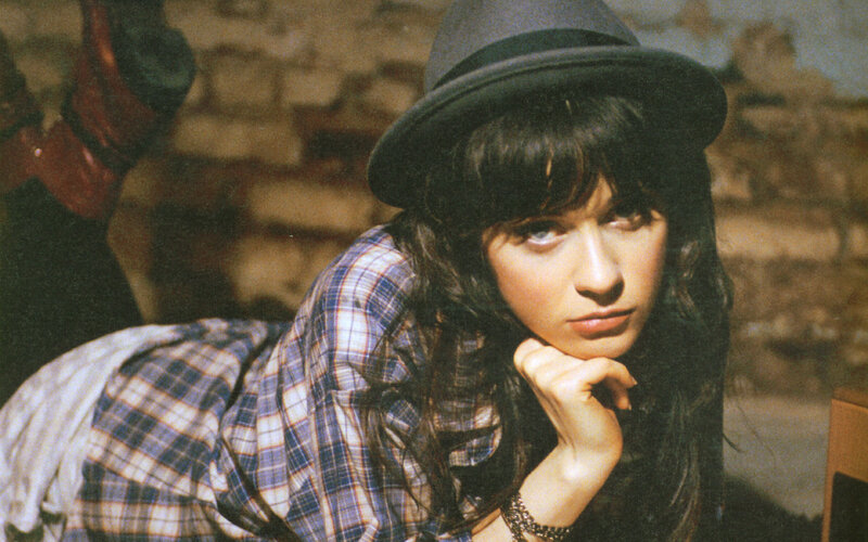 woman in hat and plaid shirt