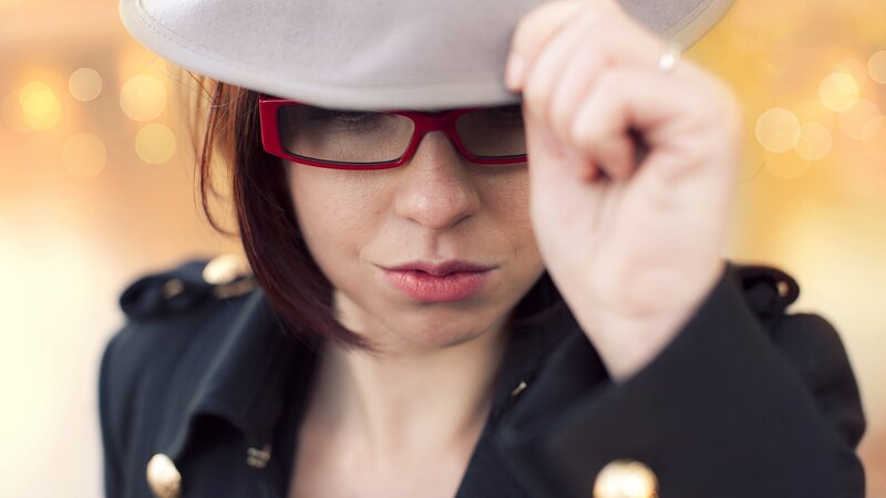 woman in hat and red glasses
