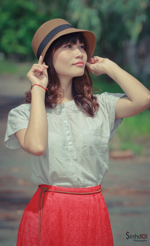 woman in hat and red skirt