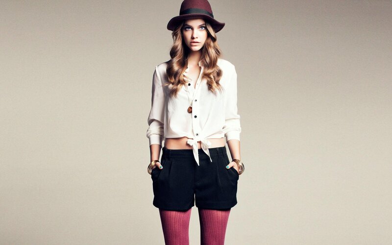 woman in hat and shorts