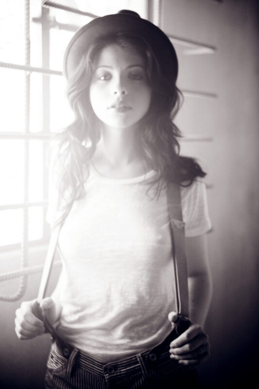 woman in hat and suspenders