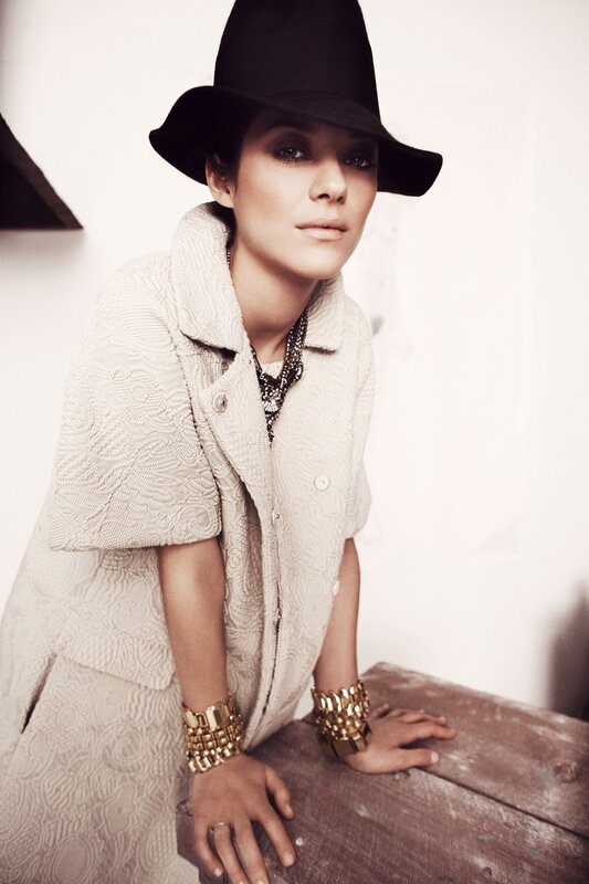 woman in hat and textured coat