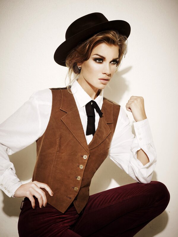 woman in hat and vest