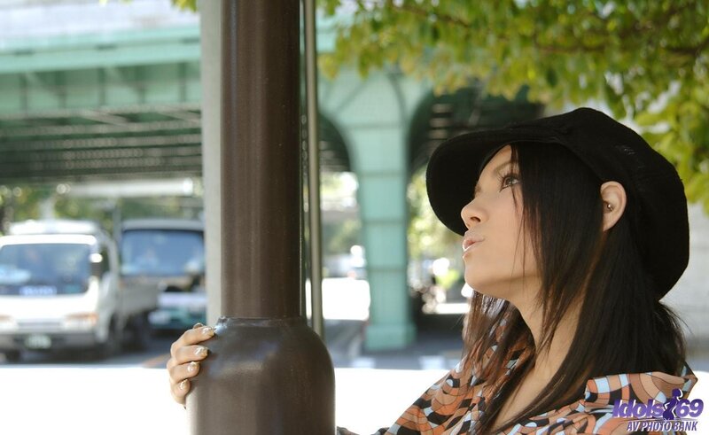 woman in hat at bus stop