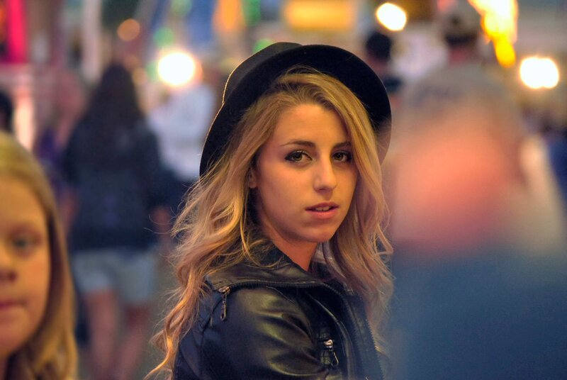 woman in hat at night event