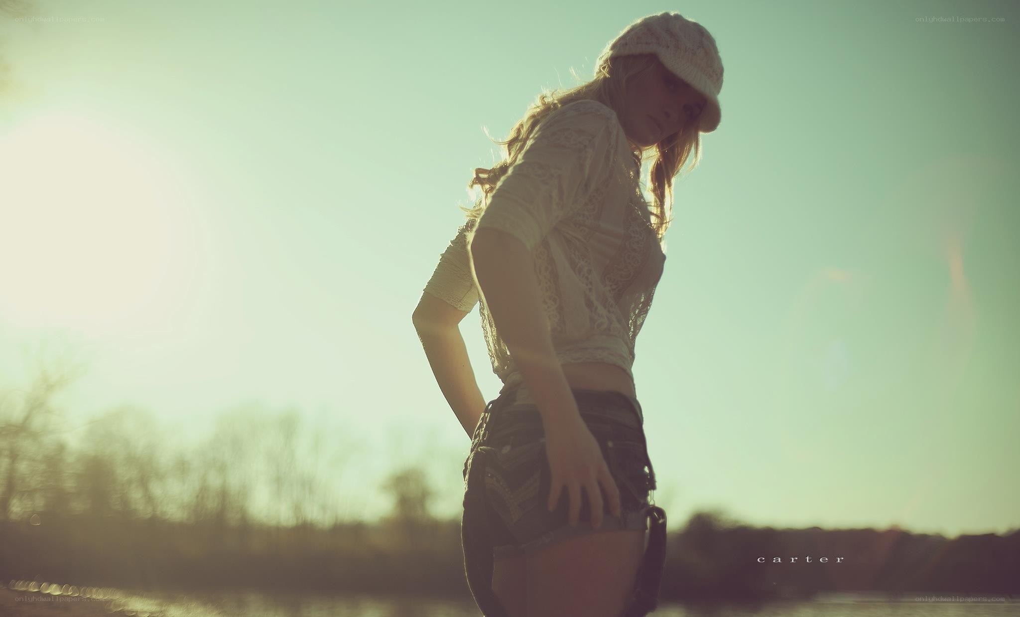 woman in hat at sunset