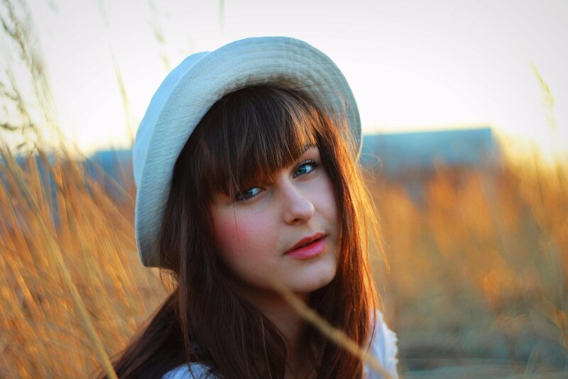 woman in hat at sunset