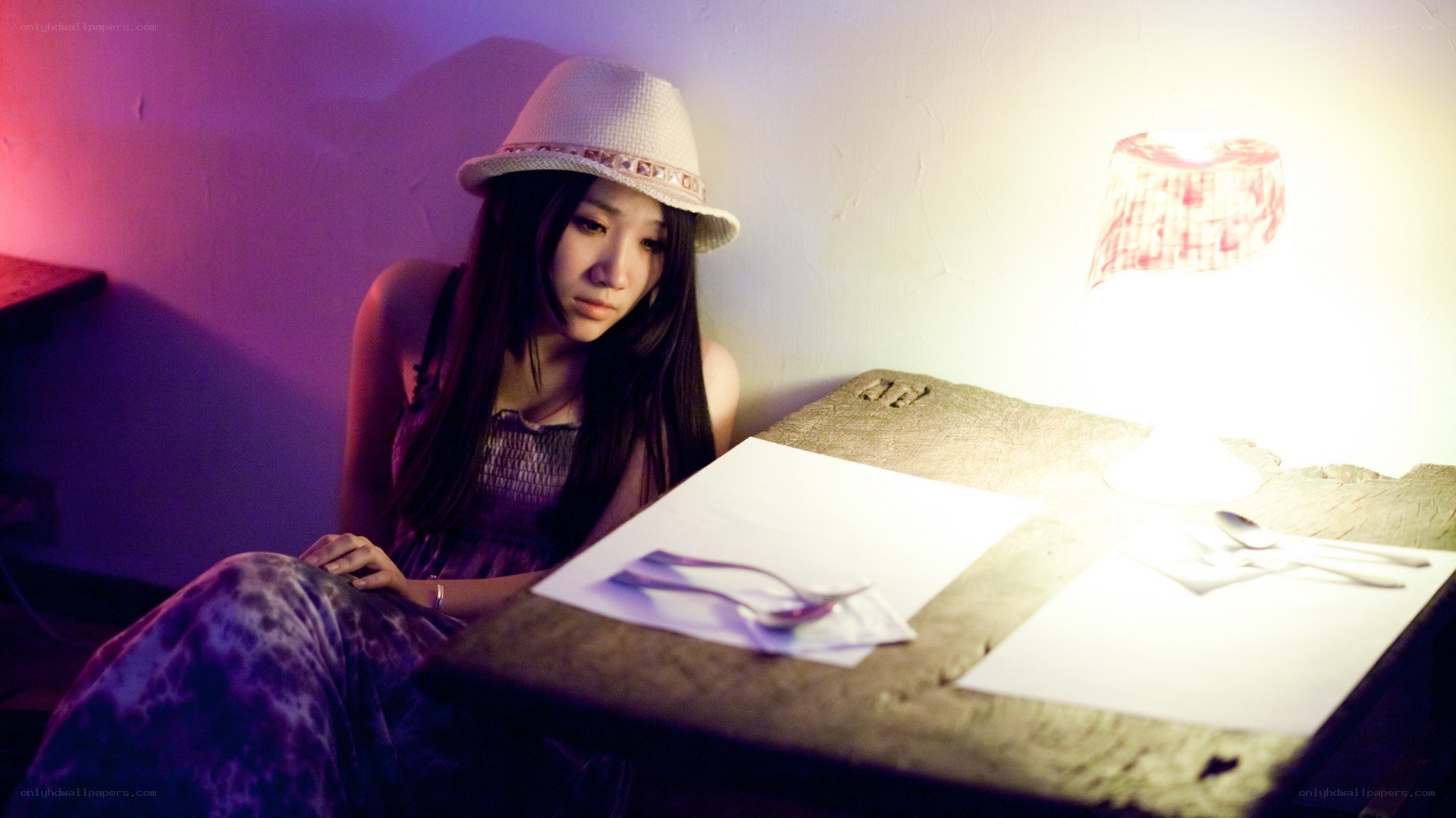 woman in hat at table