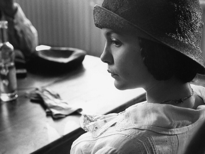 Woman in Hat at Table — Black
