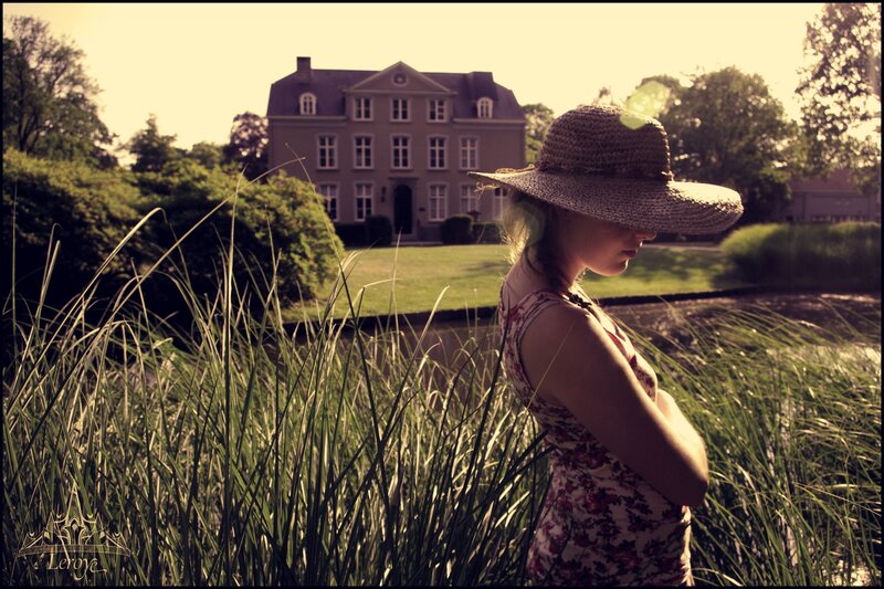 Woman in hat by a pond