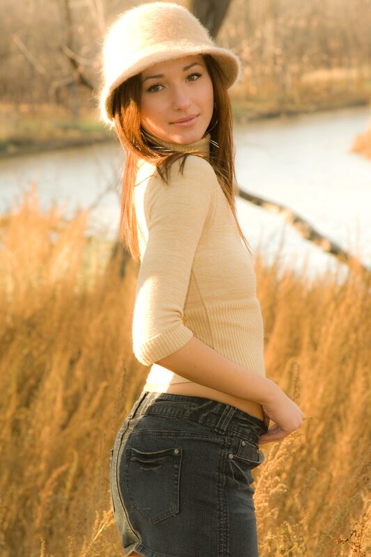 woman in hat by river