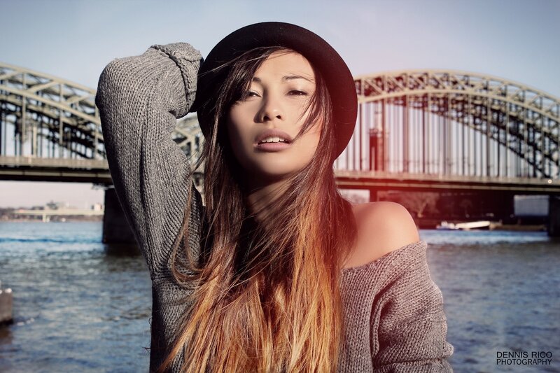 woman in hat by river