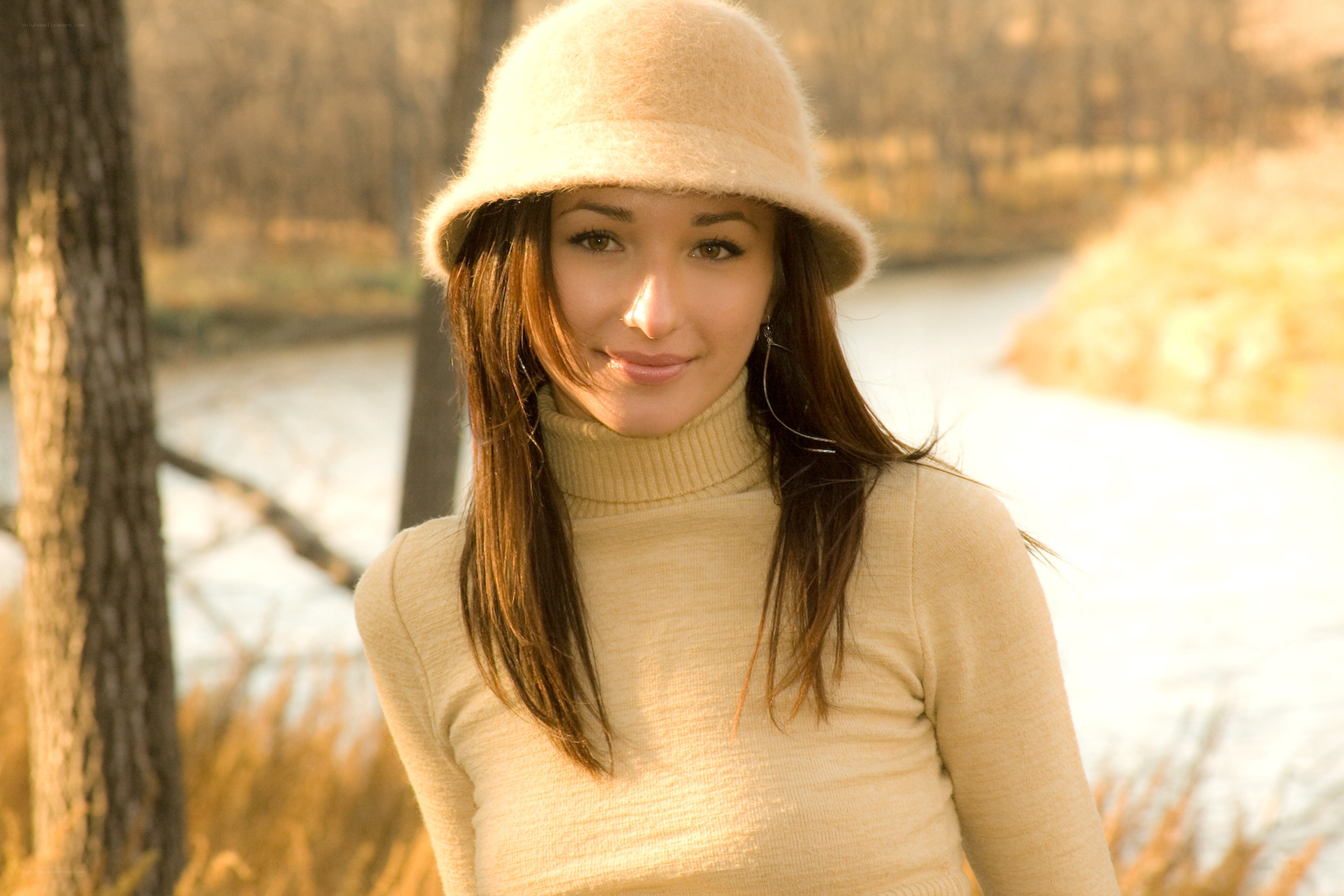 woman in hat by river