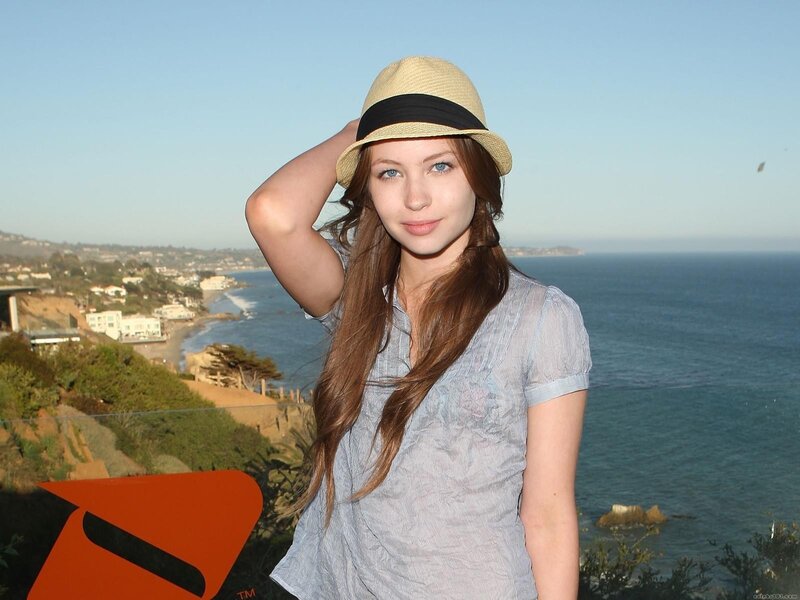 woman in hat by the ocean