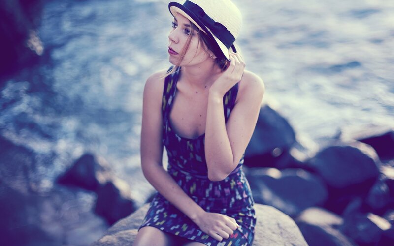 woman in hat by the sea