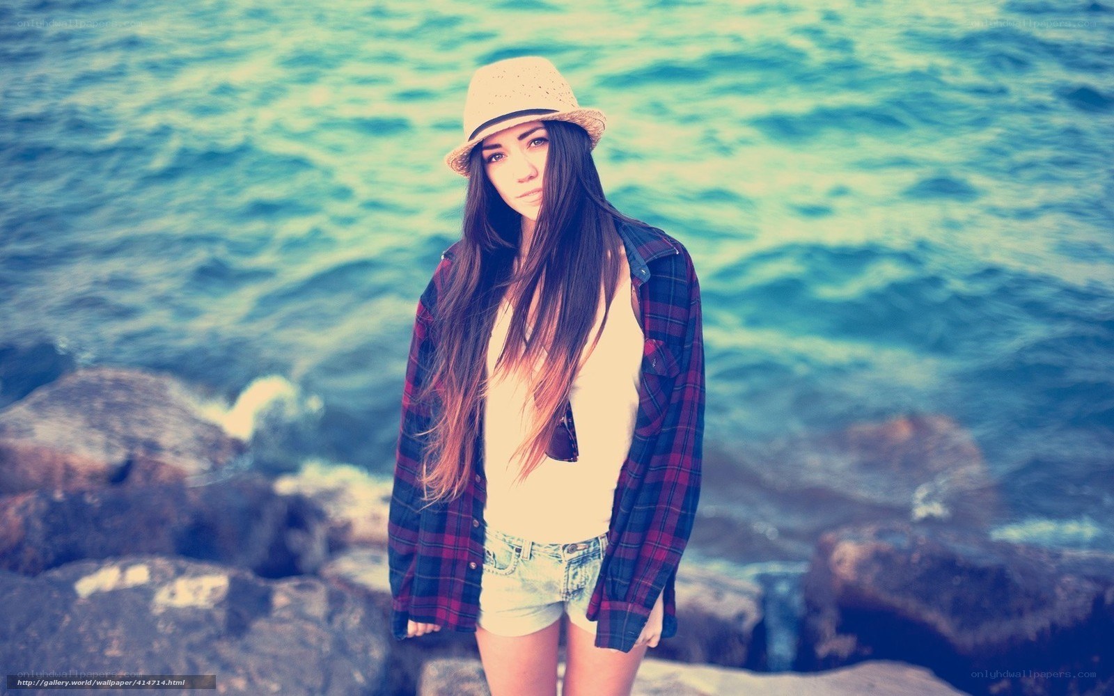 woman in hat by the sea