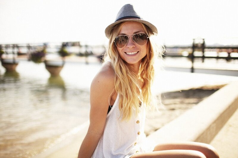woman in hat by the water