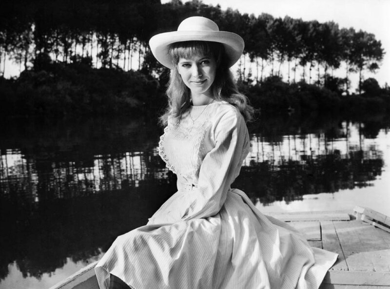 woman in hat by the water