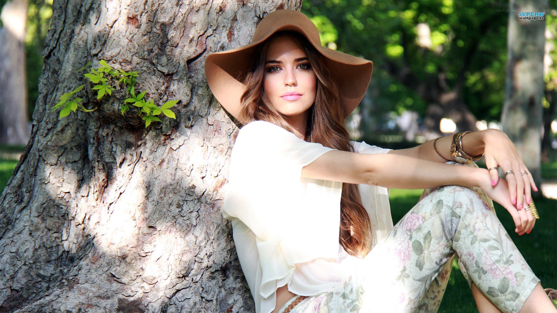 woman in hat by tree