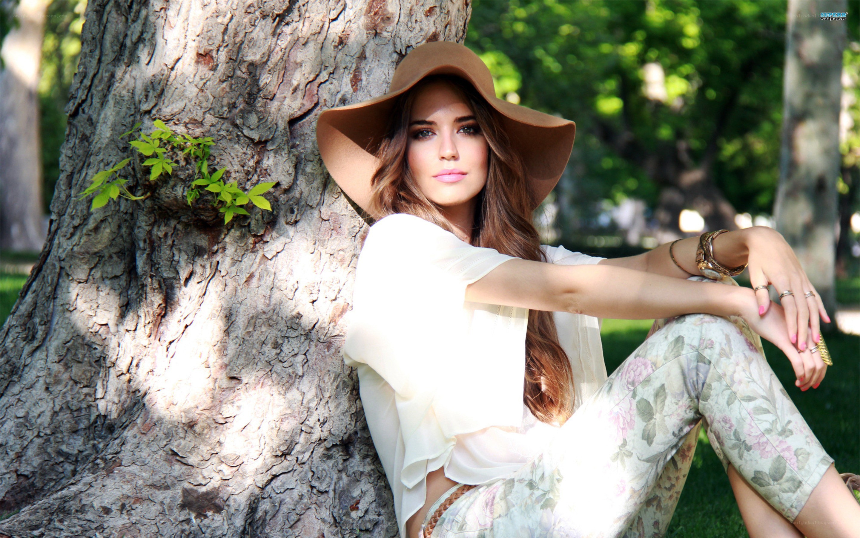 woman in hat by tree