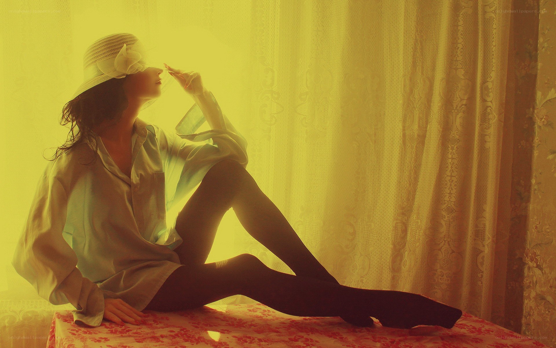 woman in hat by window