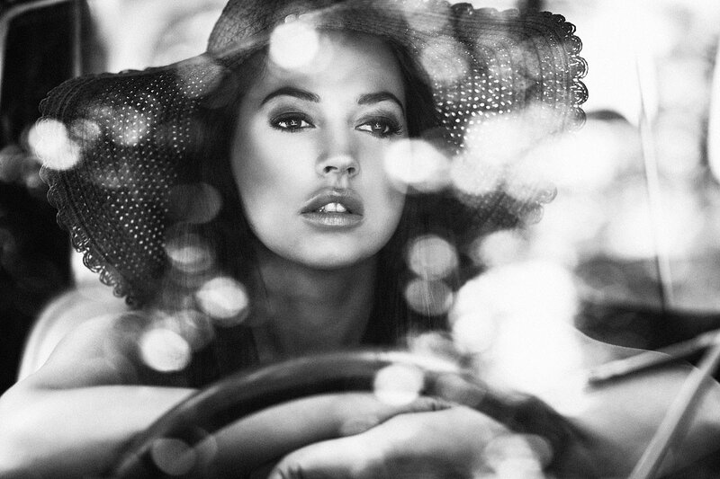woman in hat driving car