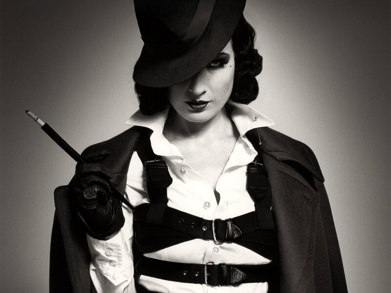 woman in hat holding cigarette