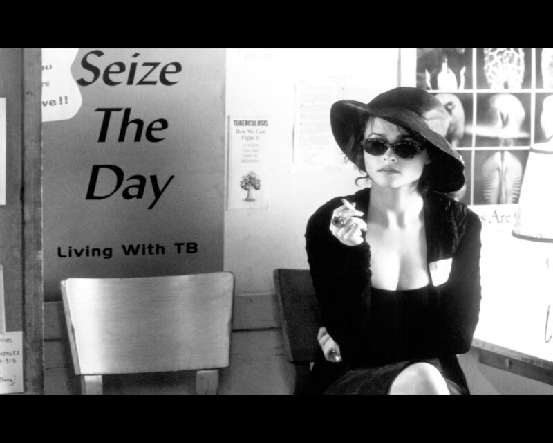Woman in hat holding cigarette