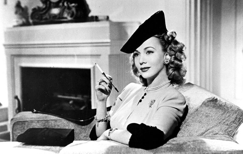 Woman in hat holding cigarette