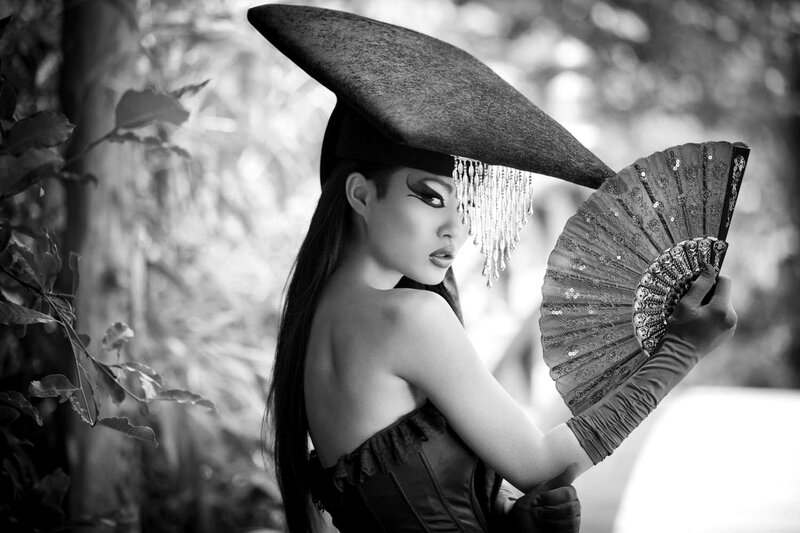 Woman in Hat Holding Fan