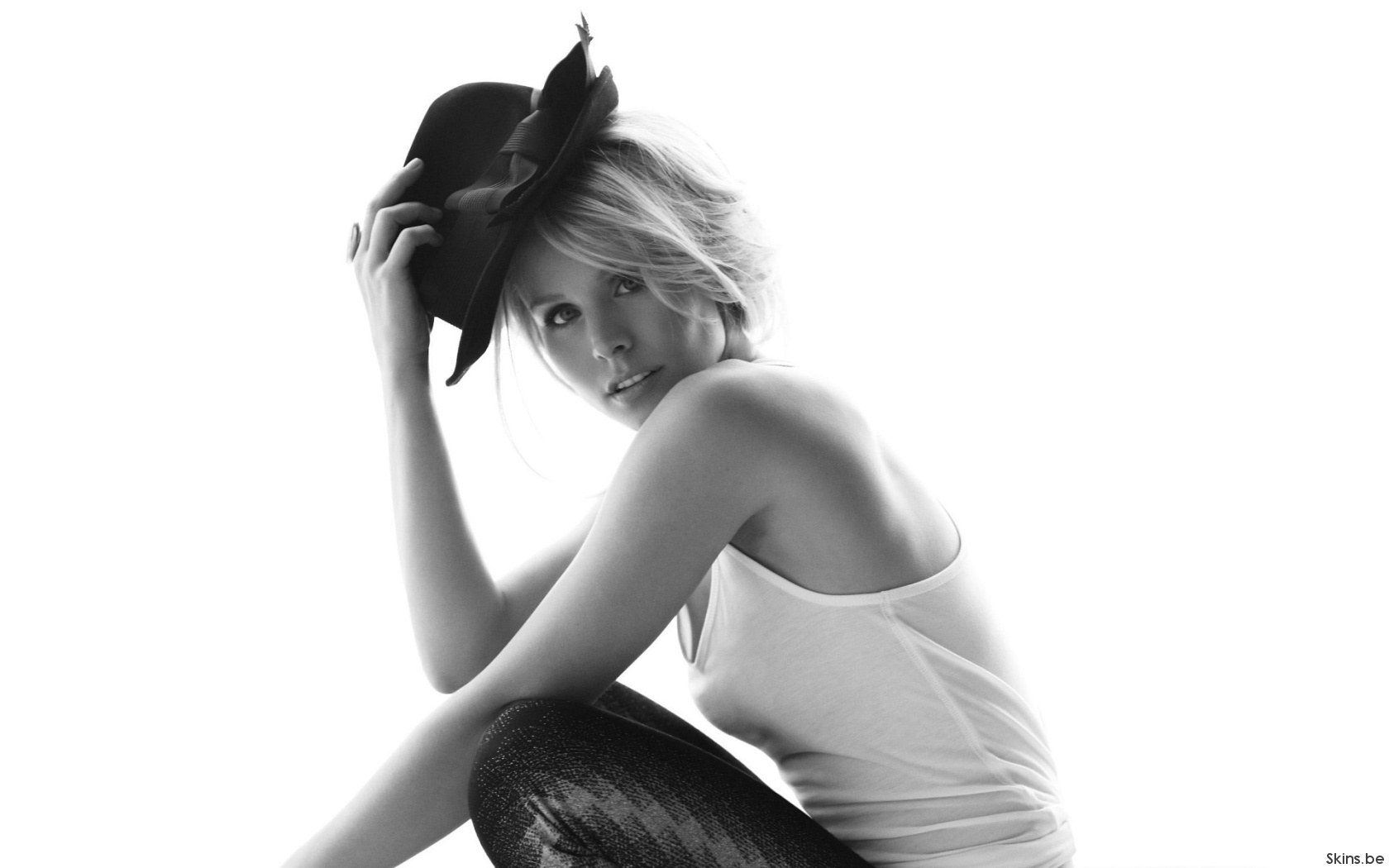 woman in hat holding head