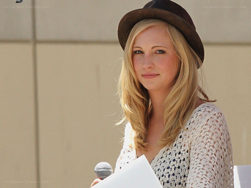 Woman in hat holding microphone