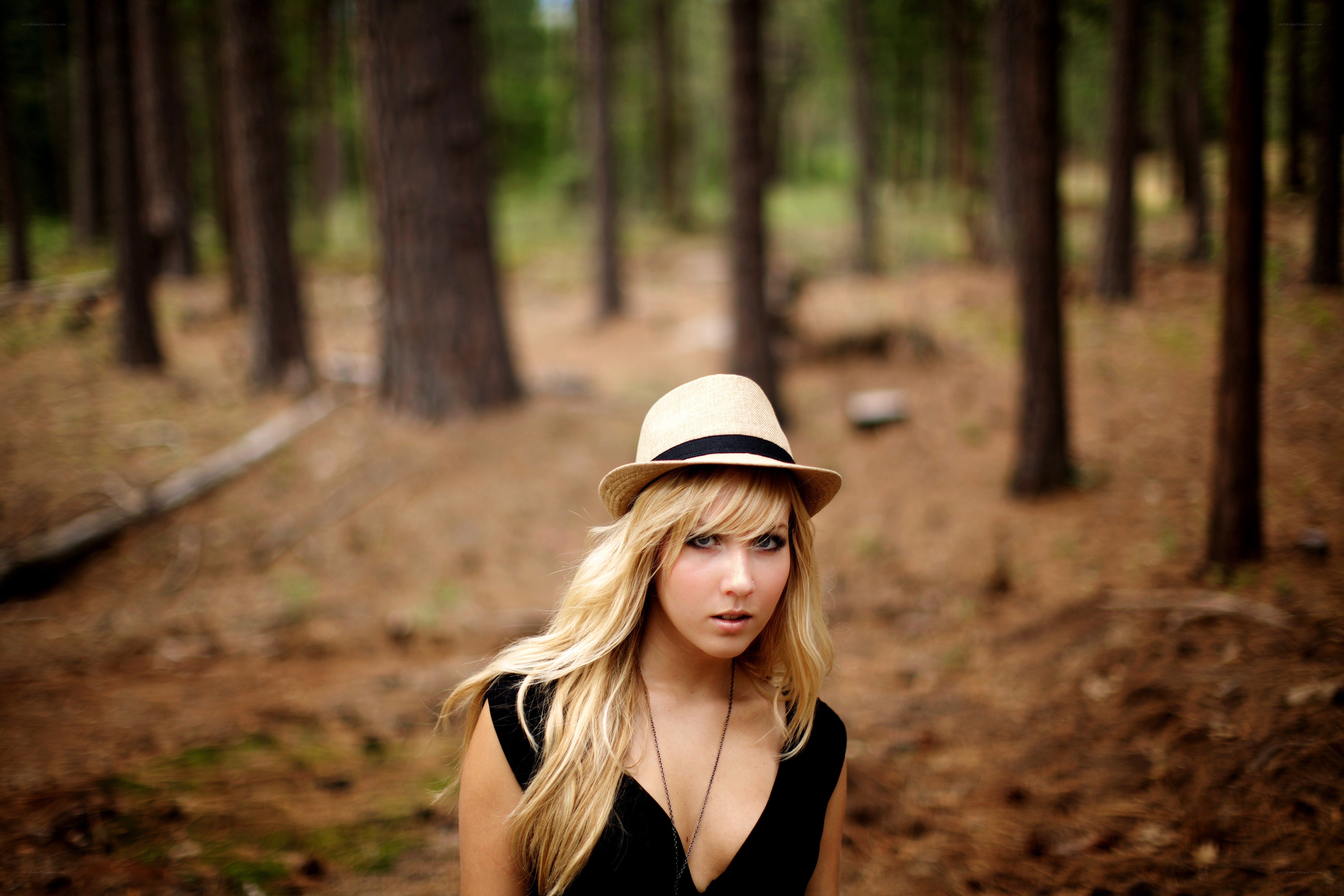 woman in hat in forest
