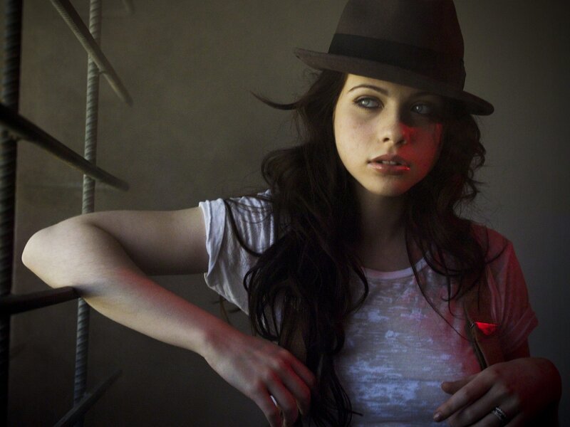 woman in hat leaning on railing