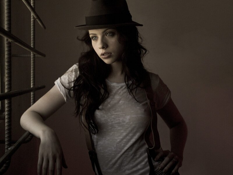 woman in hat leaning on railing