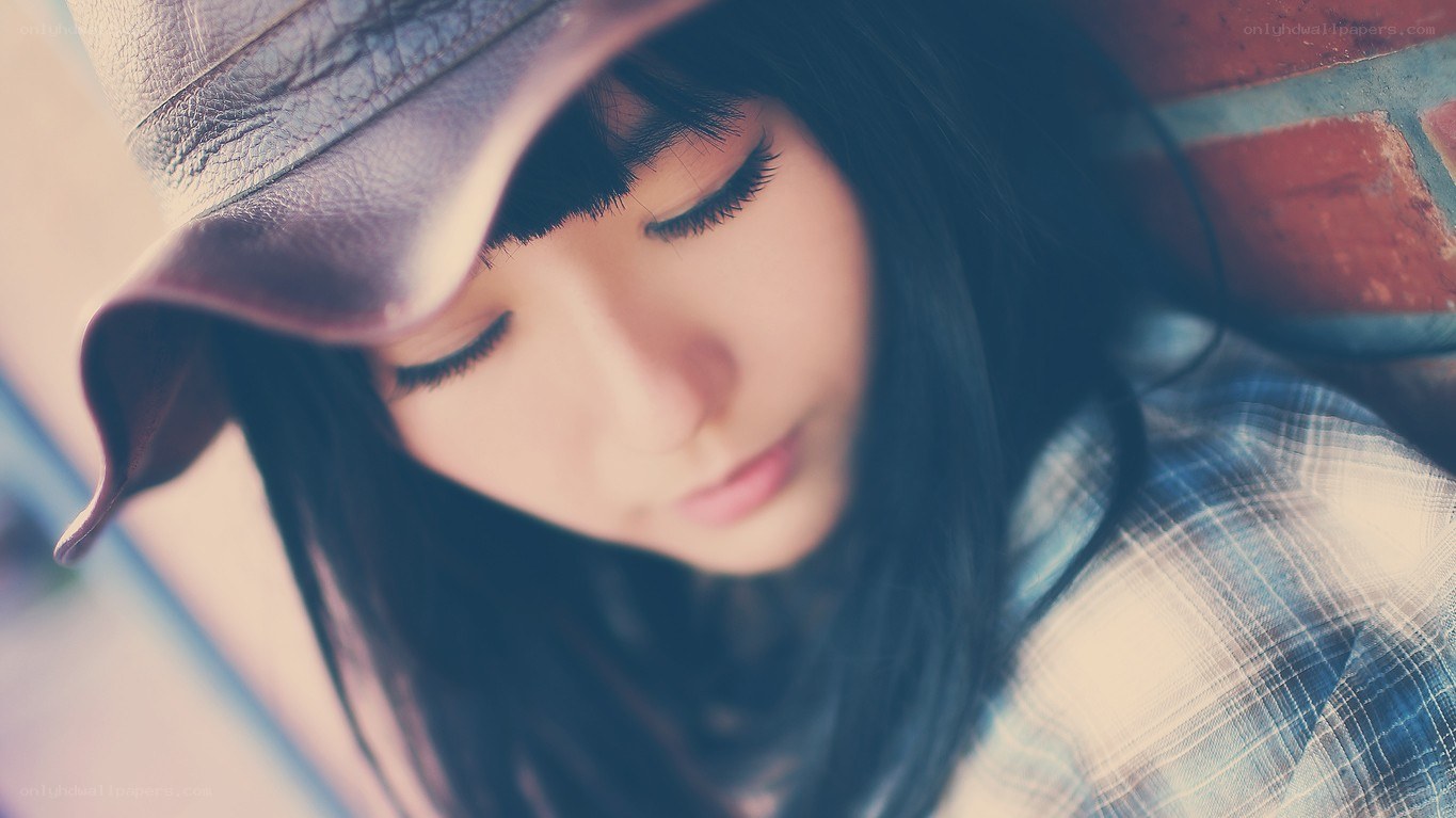 woman in hat looking down